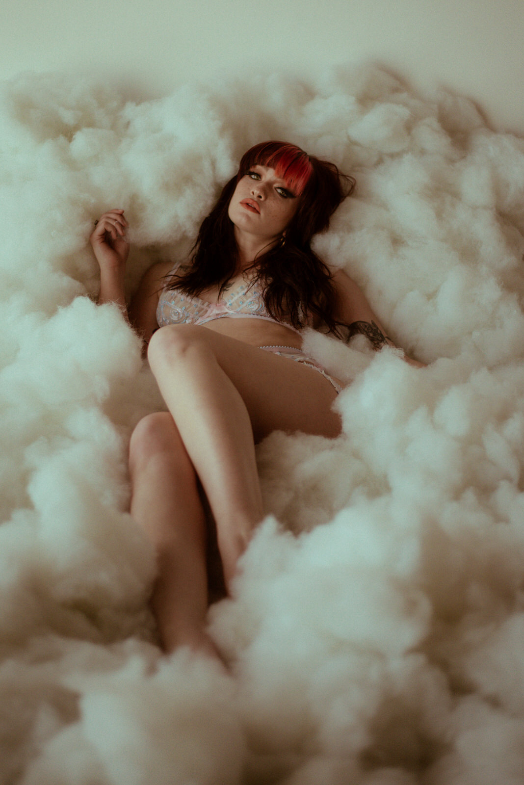 Woman laying nude in cloud photography set in Dallas 