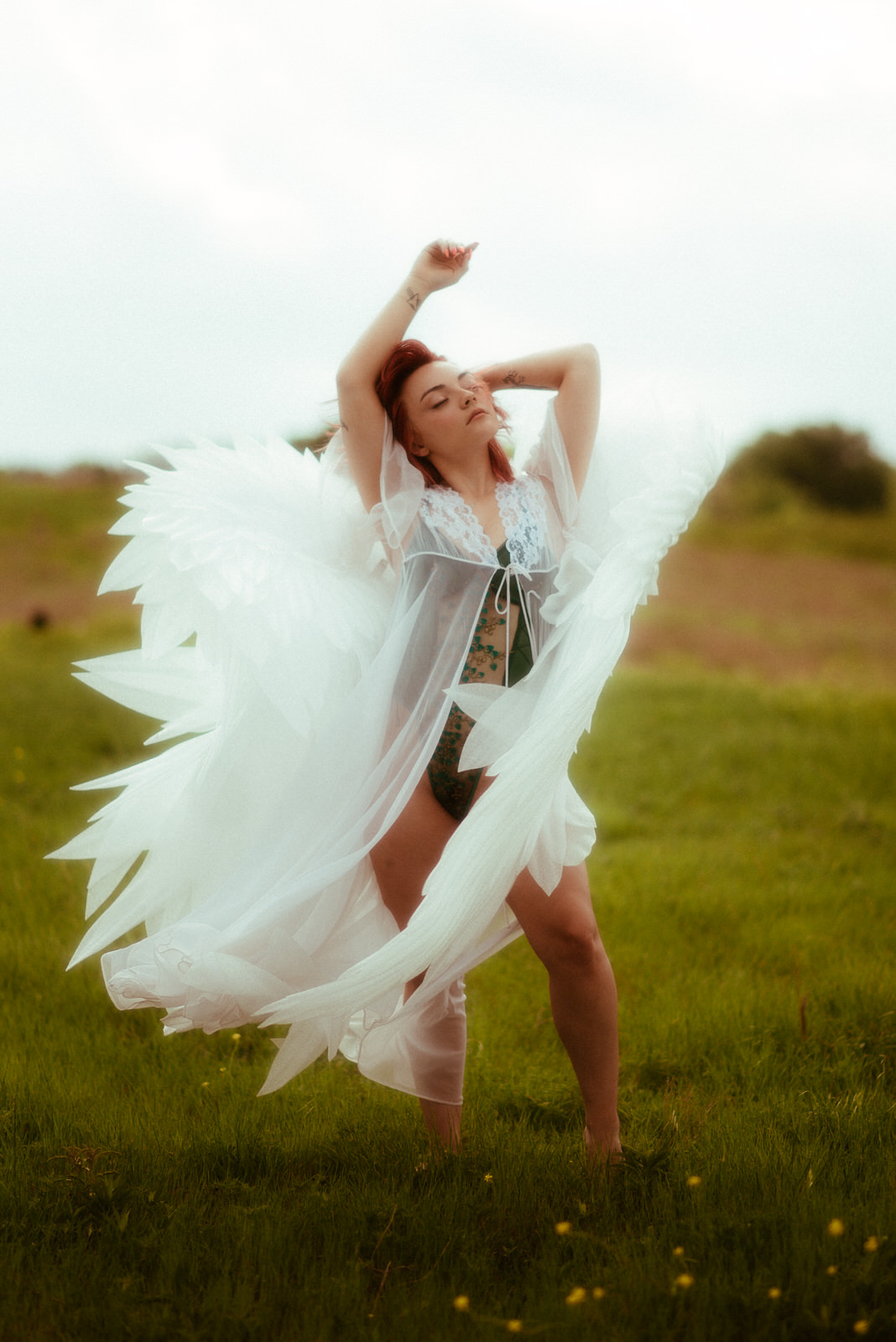 Outdoor photoshoot with large angel wings blowing in the wind