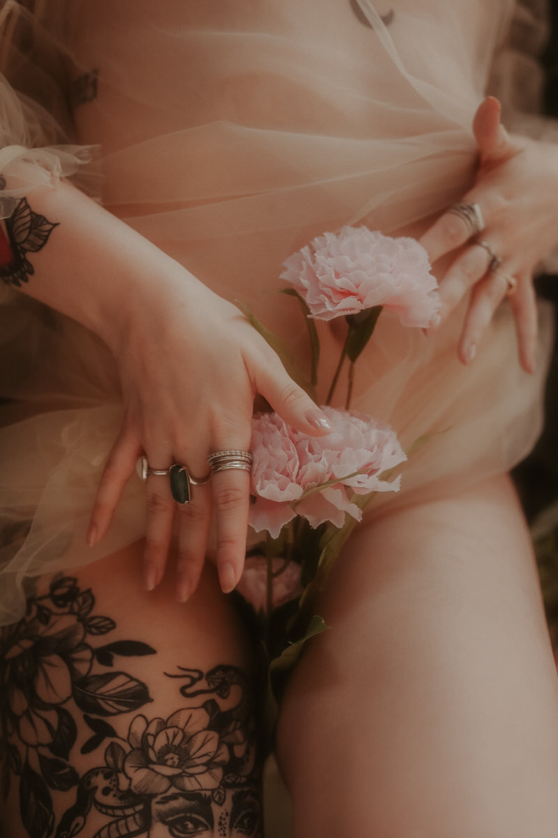 Woman with flowers between her legs.
