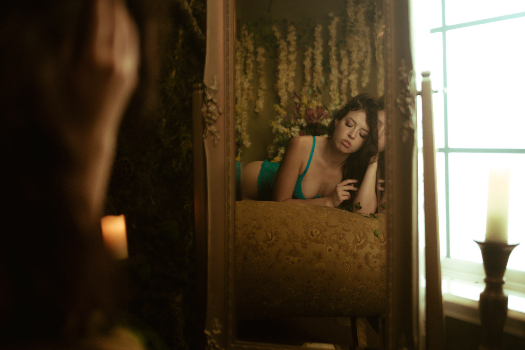 Dallas Boudoir Photography: A woman savoring her reflection on a bed.