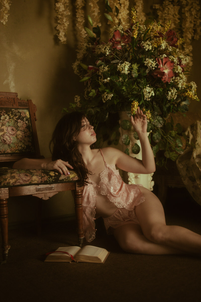 A woman in pink lingerie posing for Dallas Boudoir Photography.