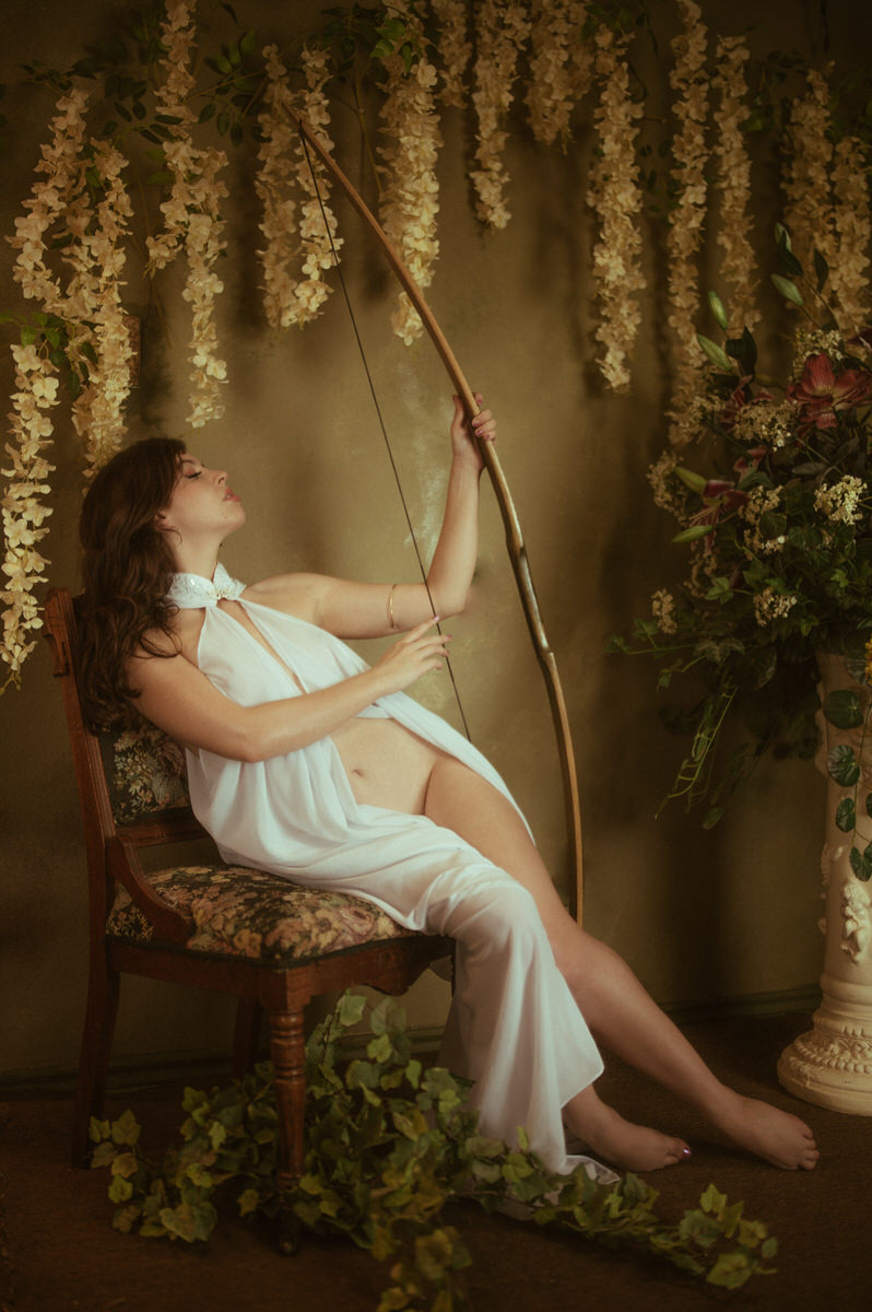 Dallas boudoir photography showcasing a woman with a bow and arrow.