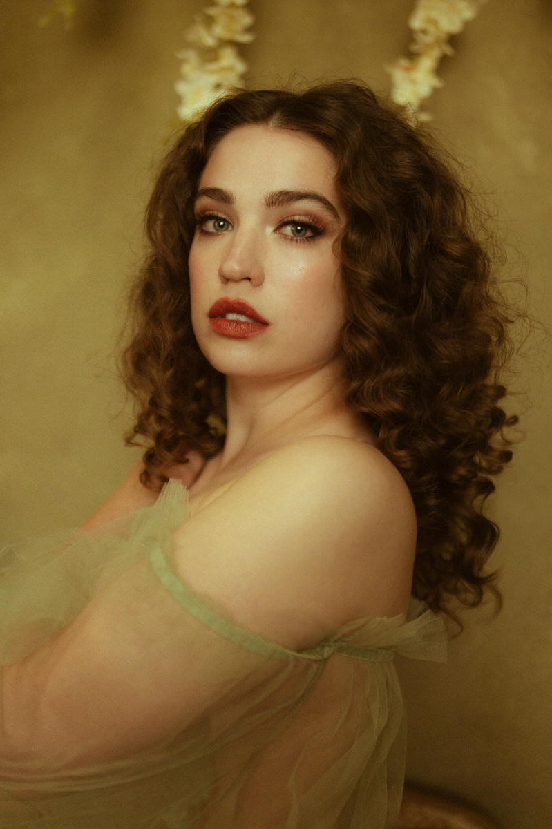 A beautiful boudoir portrait of a woman with curly hair and red lips in Dallas.