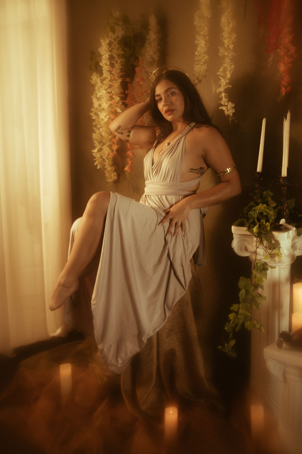 a woman in a dress posing with Greek styled columns for a picture for a libra photoshoot in Dallas, TX.