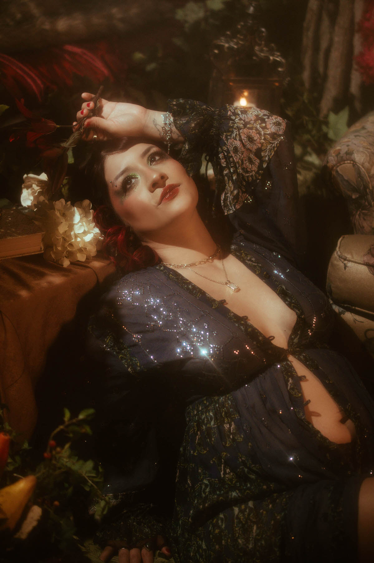 Moody maternity boudoir photo of a mother-to-be in a reflective, introspective pose, leaning against a classical column with intricate sculptural details. The golden tones and soft lighting create a cinematic effect, perfect for artistic maternity portraits.