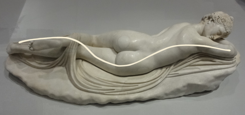 A marble statue of a reclining nude figure with a line drawn to emphasize the sensual S-curve of the body, illustrating a classical foundation for boudoir posing. The relaxed posture and flowing drapery evoke timeless inspiration for painterly boudoir photography.