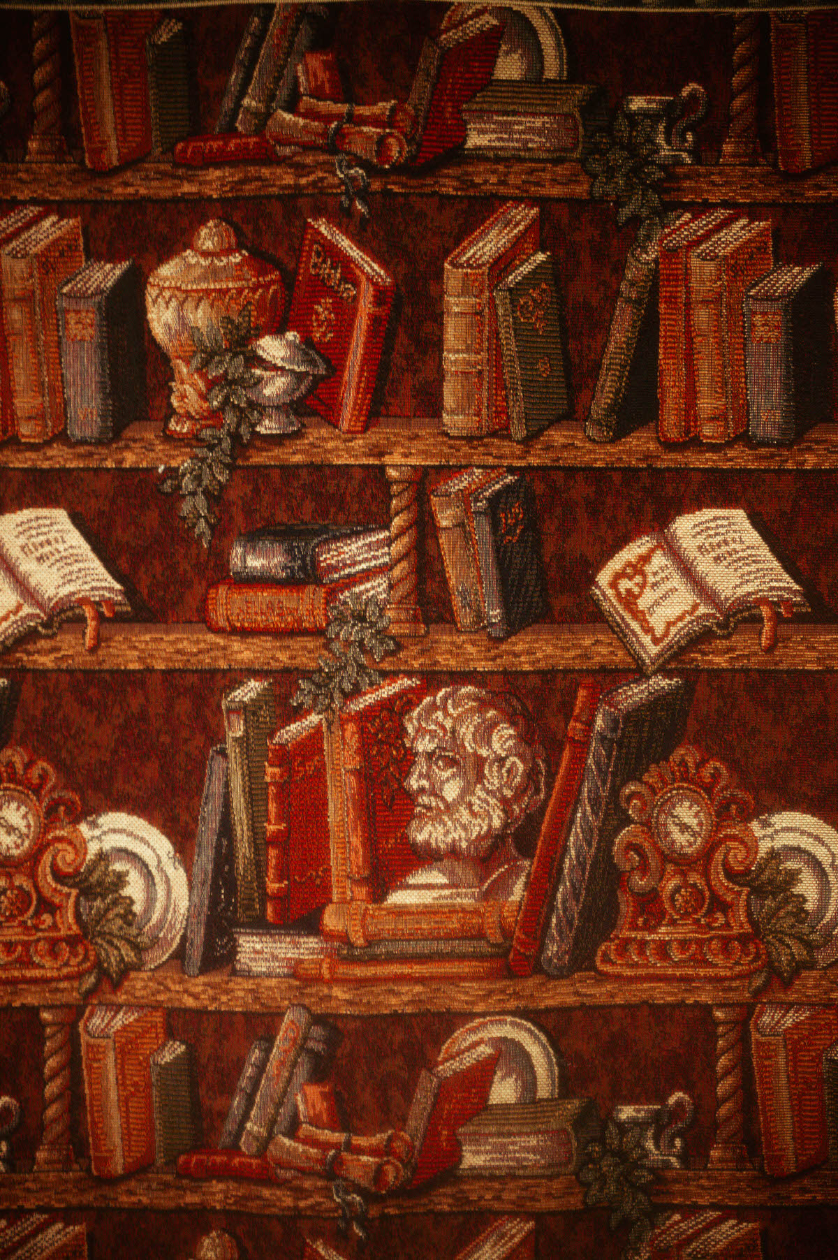 Close-up of a vintage bookshelf tapestry at Royal Lune Studio, featuring embroidered books, scrolls, Greek busts, and ornamental clocks in rich red and gold tones—part of the Dallas boudoir studio’s eclectic spring photography setup.