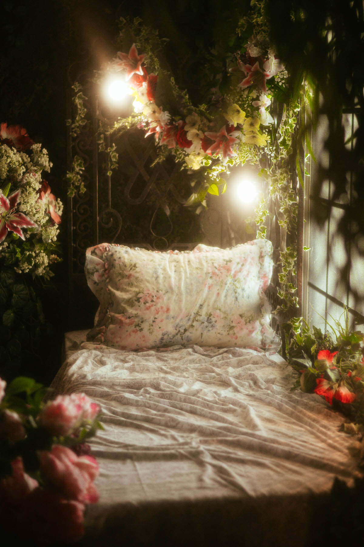 Floral daybed scene at Royal Lune Studio with soft pastel linens, dreamy window light, and cascading spring florals—part of a romantic Dallas boudoir studio and spring photography studio setup.