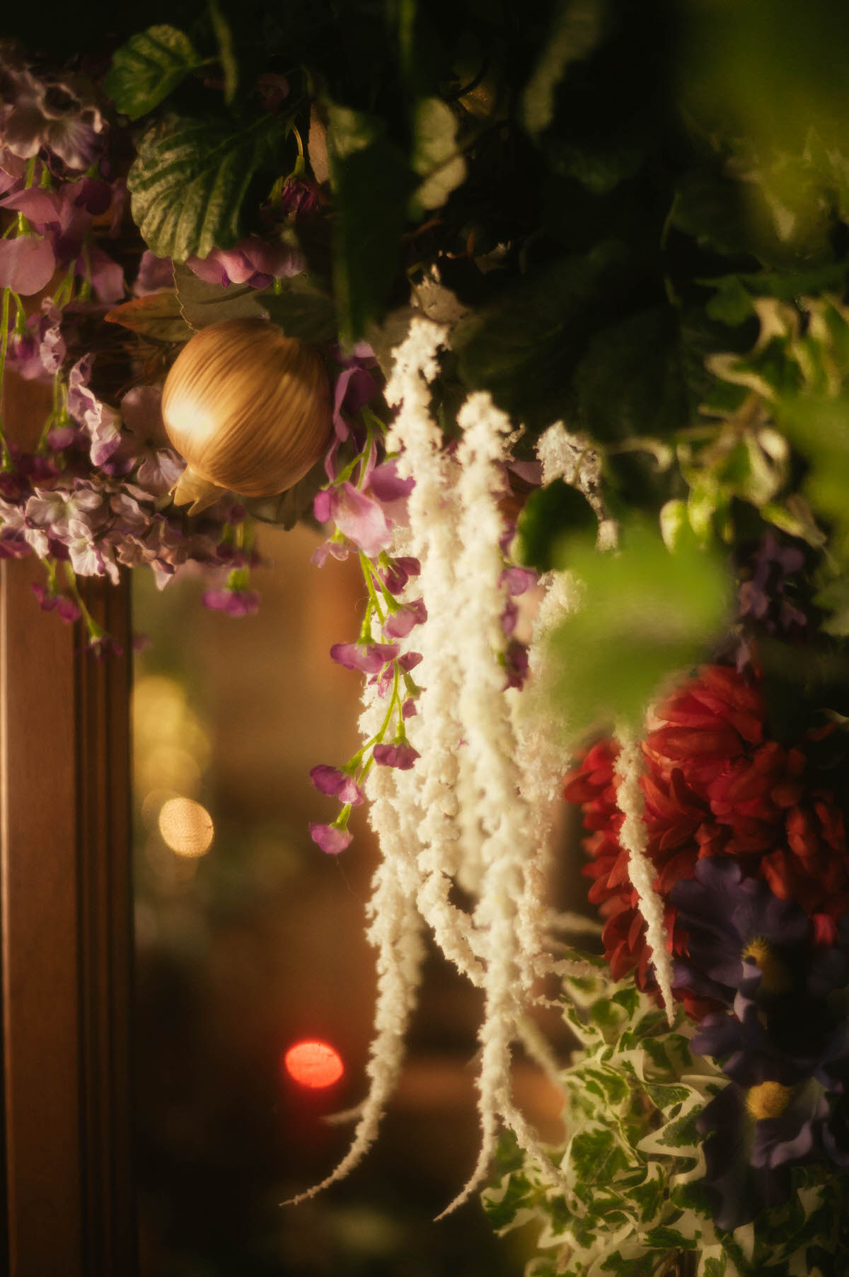 Detail shot of cascading purple silk wisteria draped over a carved wooden mirror at Royal Lune Studio, part of the spring-inspired floral styling in this Dallas boudoir studio.