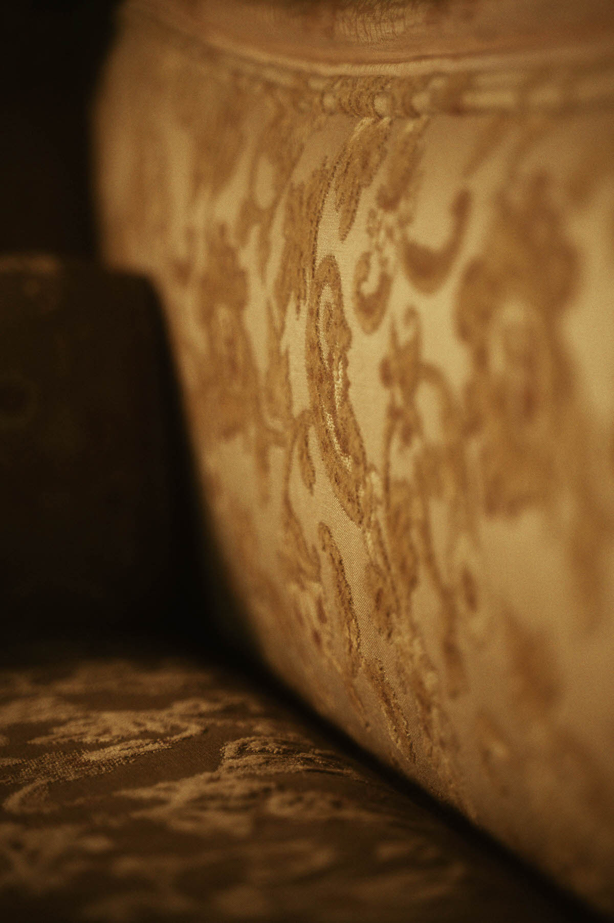 Close-up of gold floral damask upholstery on a vintage tapestry lounge chair at Royal Lune Studio, showcasing ornate textures in this Dallas boudoir studio spring setup.