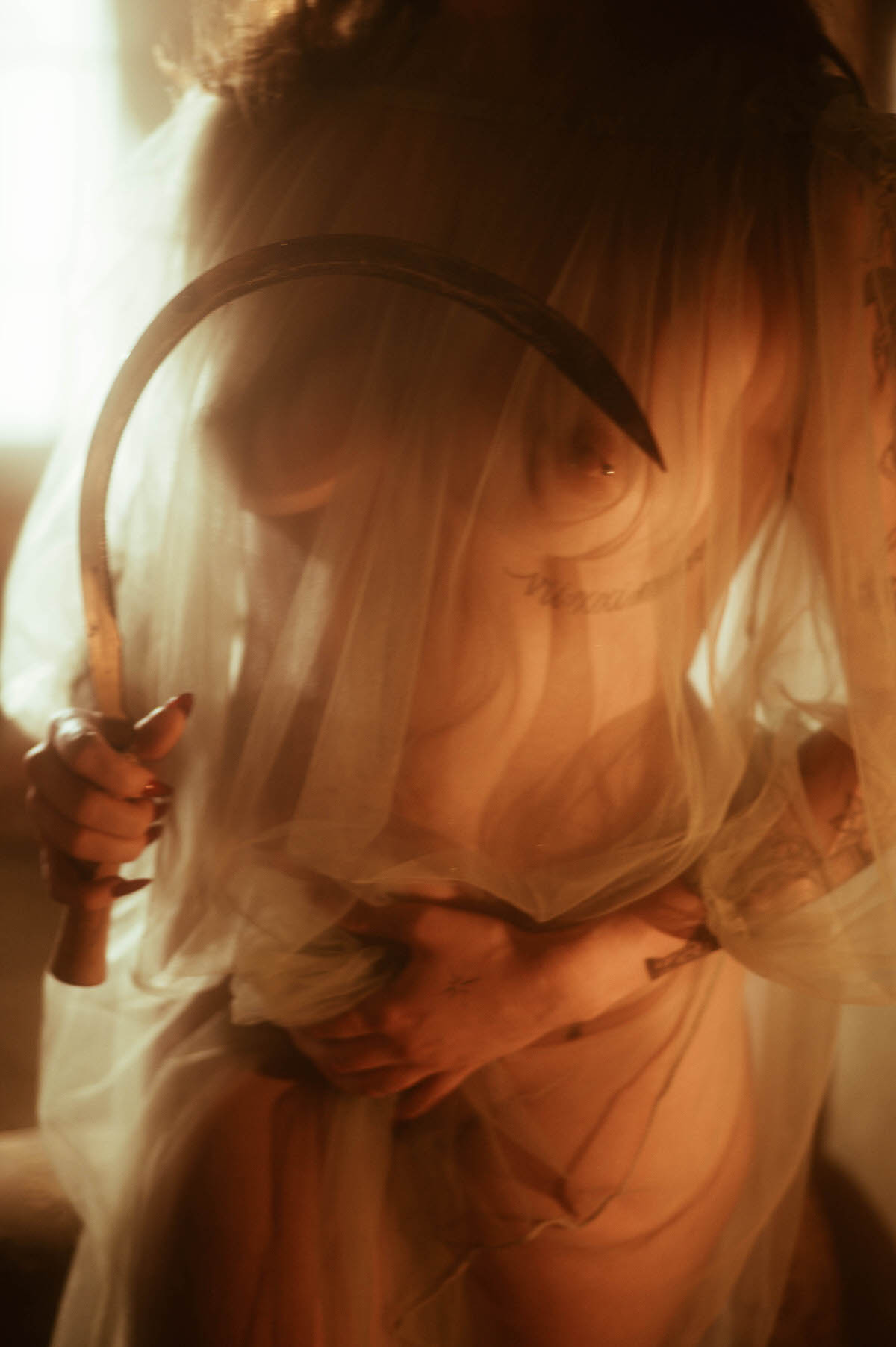A fall boudoir photoshoot detail shot shows a sickle held close against the body beneath sheer veiling, echoing the painted figure in Allegory of Summer. Royal Lune Photo.