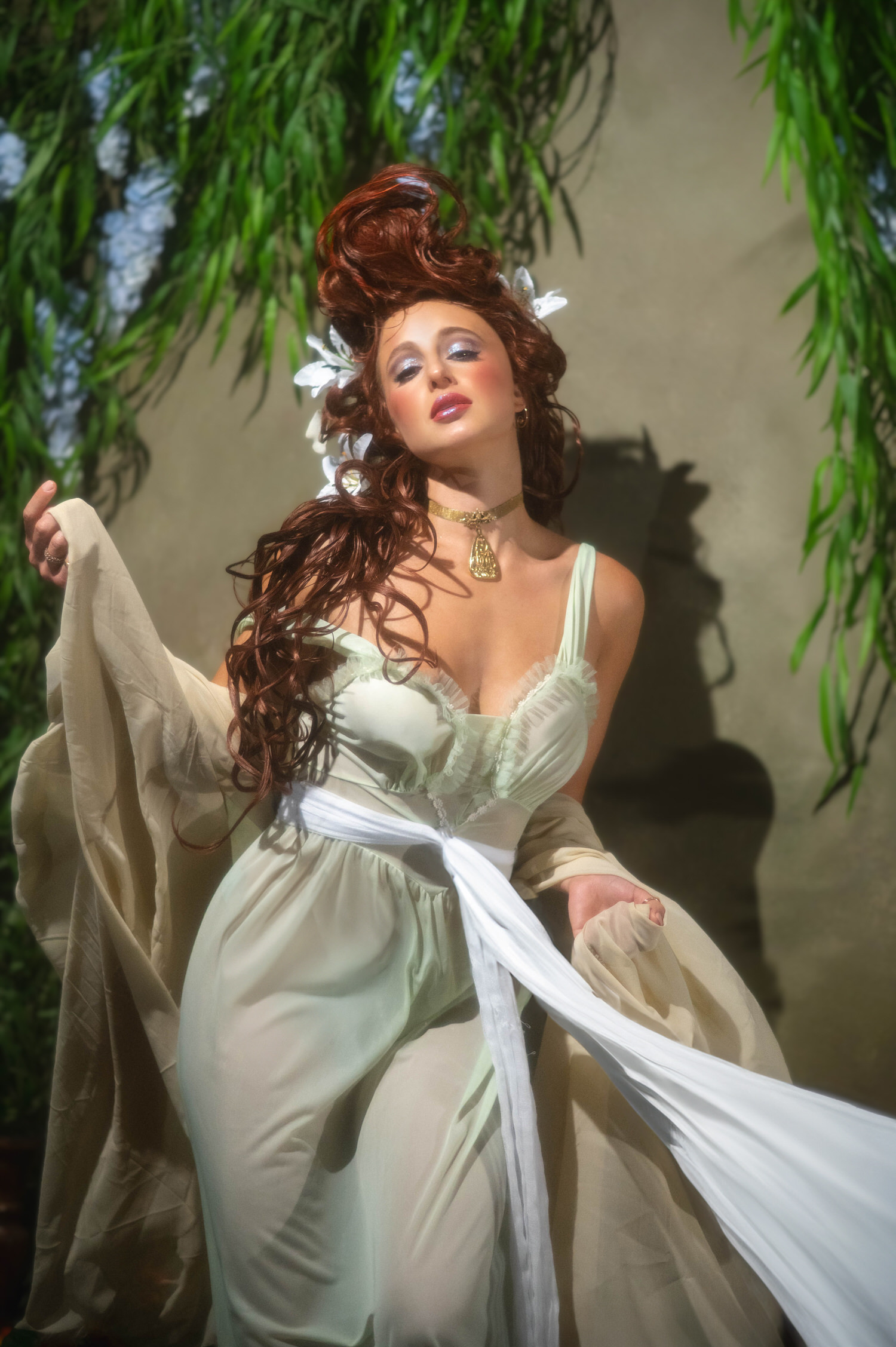 Fine art photography featuring Art Nouveau inspiration. A model in a flowing green dress poses dynamic movement inside Royal Lune Studio in the Dallas area.