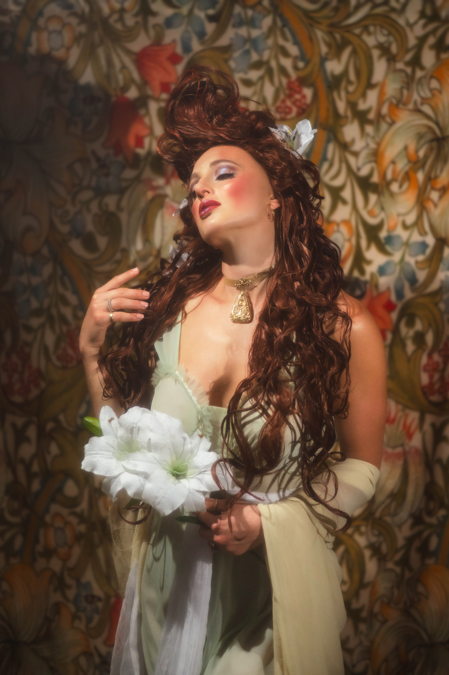 Dreamy Art Nouveau style photography. Close-up portrait of a woman with dramatic makeup, closed eyes, and an elegant updo woven with white flowers.