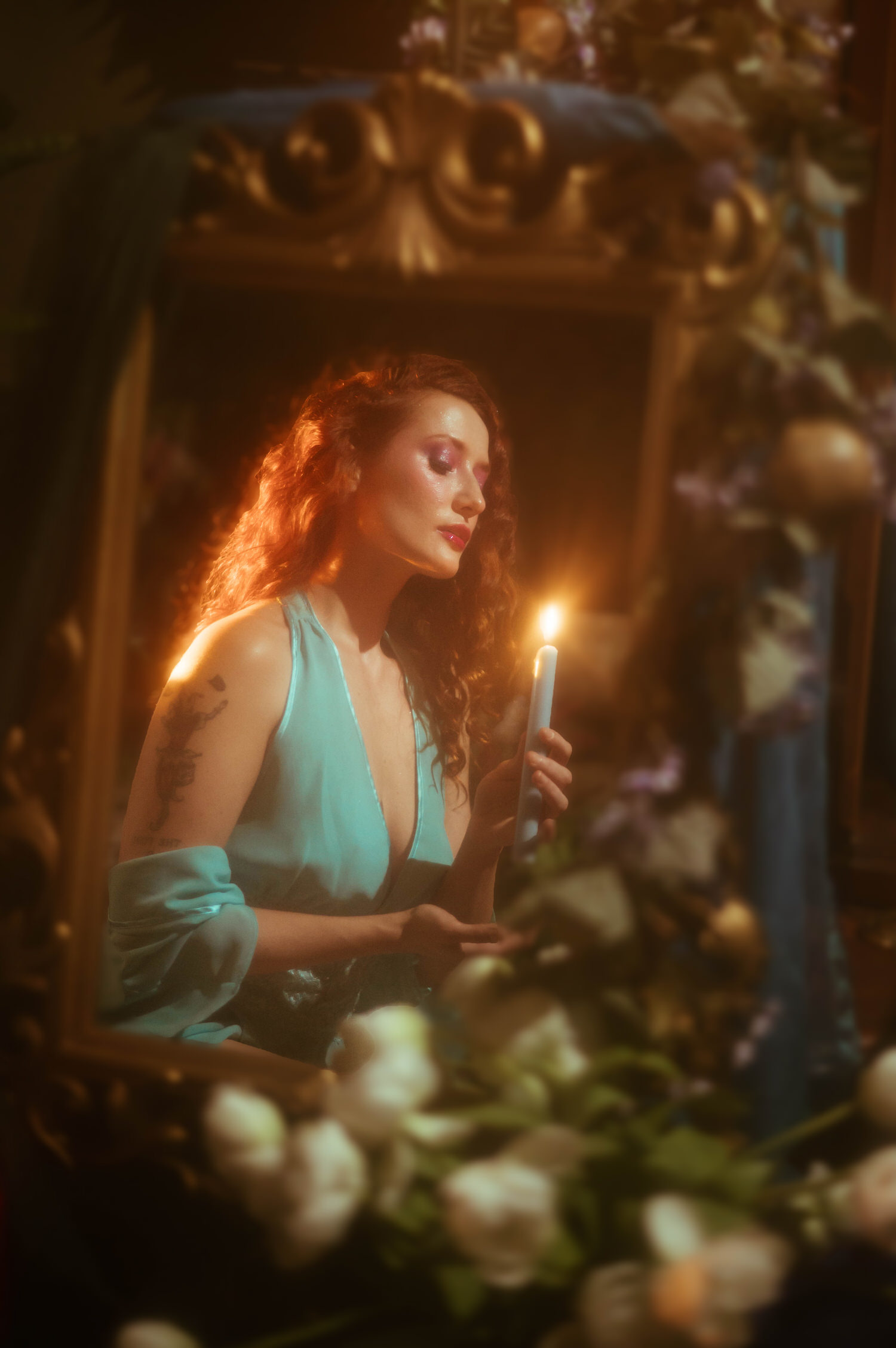 A model in a vintage lace nightgown holds a lit candle within an ornate gold mirror frame, capturing the dreamy photography studio aesthetic of a Midsummer Night's Dream inspired session. This fine art portrait was shot at a Dallas area studio. Royal Lune Photo.