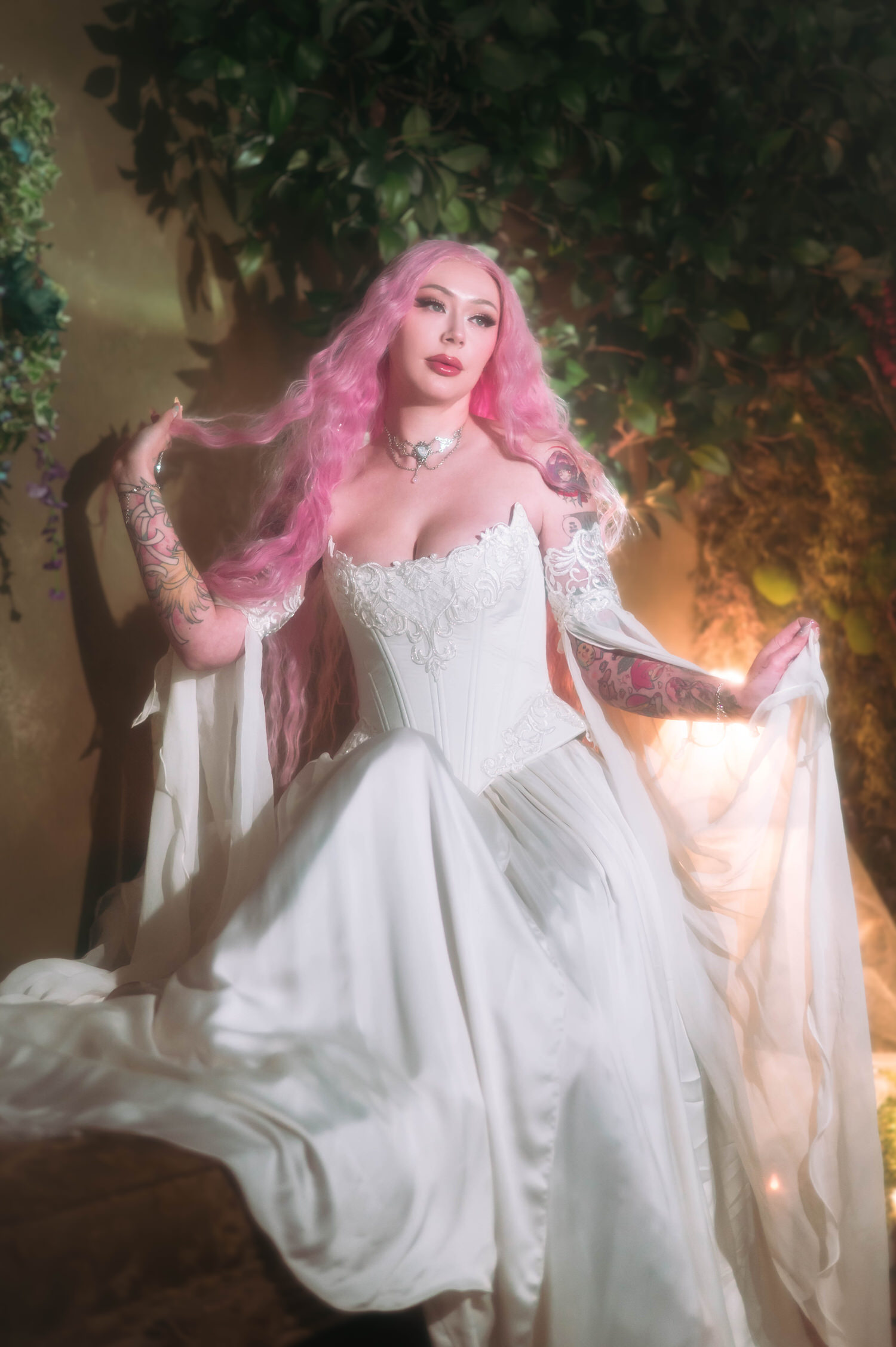 Elegant bridal portrait featuring a firefly path bridal gown with embroidered corset and layered skirt, styled with soft candlelit haze.