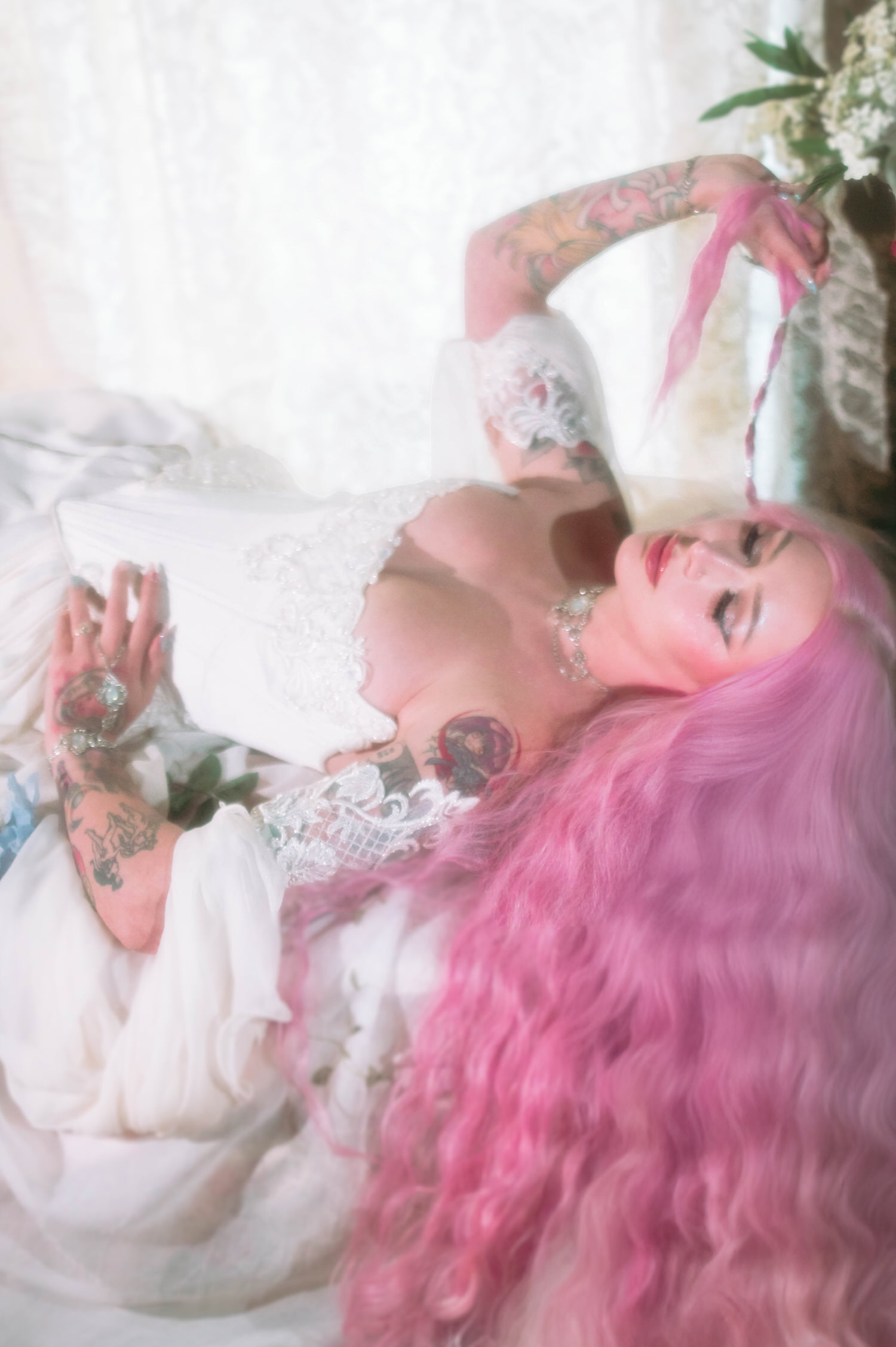 Bridal flat-lay style portrait of fantasy bridal photos featuring embroidered corset bodice, blue hydrangeas, and flowing ivory skirt.