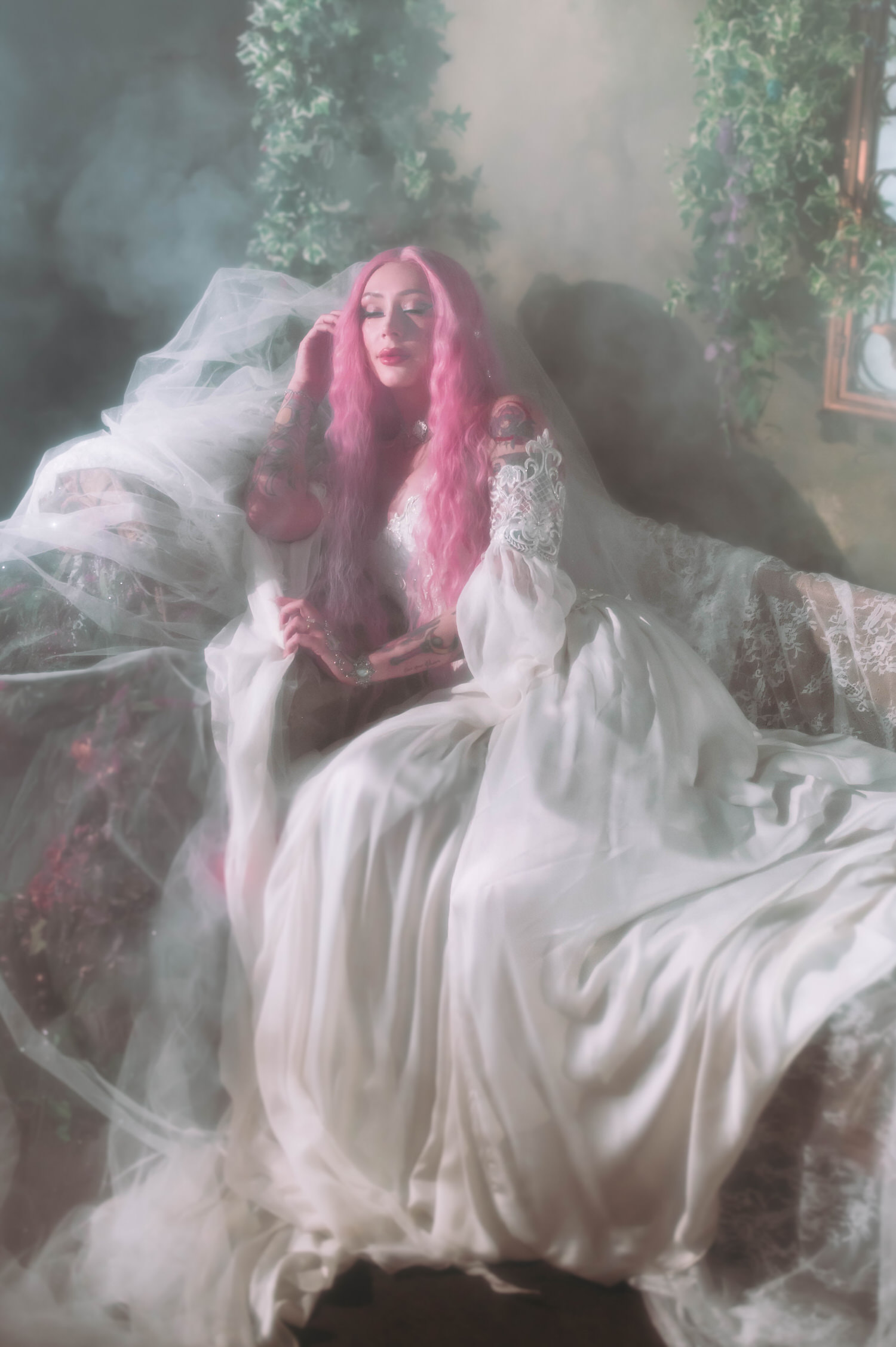 Renaissance fair wedding photography inspired bridal portrait with pink-haired bride in lace corset fantasy bridal gown, seated among ivy columns and ethereal mist.