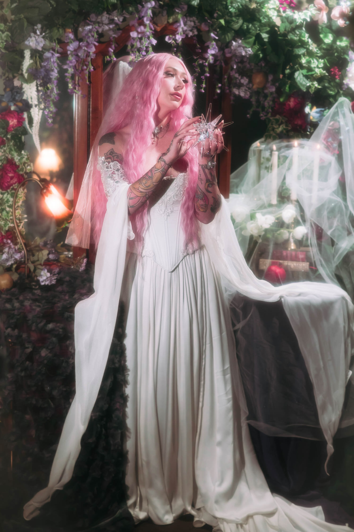 Renaissance fair wedding photography inspired bridal portrait featuring a firefly path bridal gown, ivy-covered mirror, and soft glowing candlelight.