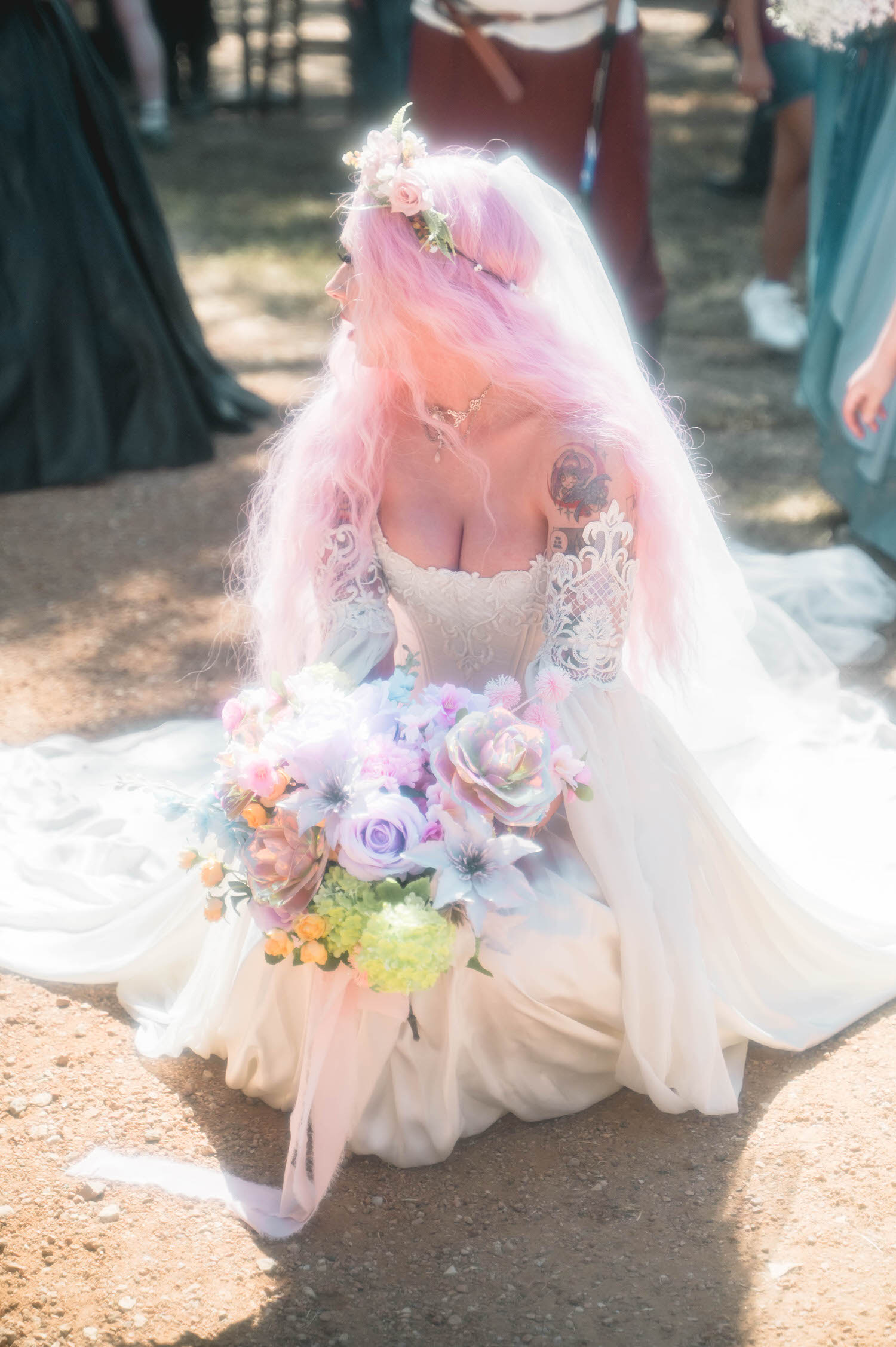 A close up of the bride from behind shows her pink hair, sheer veil, and the intricate lace detailing on the sleeves of her Firefly Path Bridal Gown. Fine details like this are a priority when documenting a Texas Renaissance Festival wedding. Royal Lune Photo.