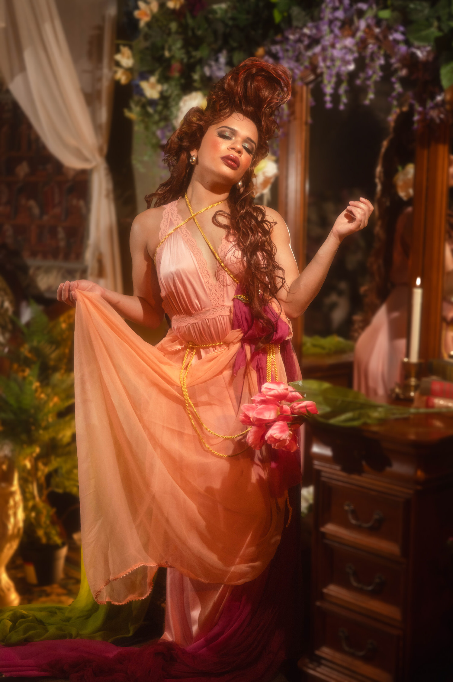 Woman in a peach chiffon skirt and pink halter nightgown holding pink tulips while standing before an antique vanity mirror, Royal Lune Photo.