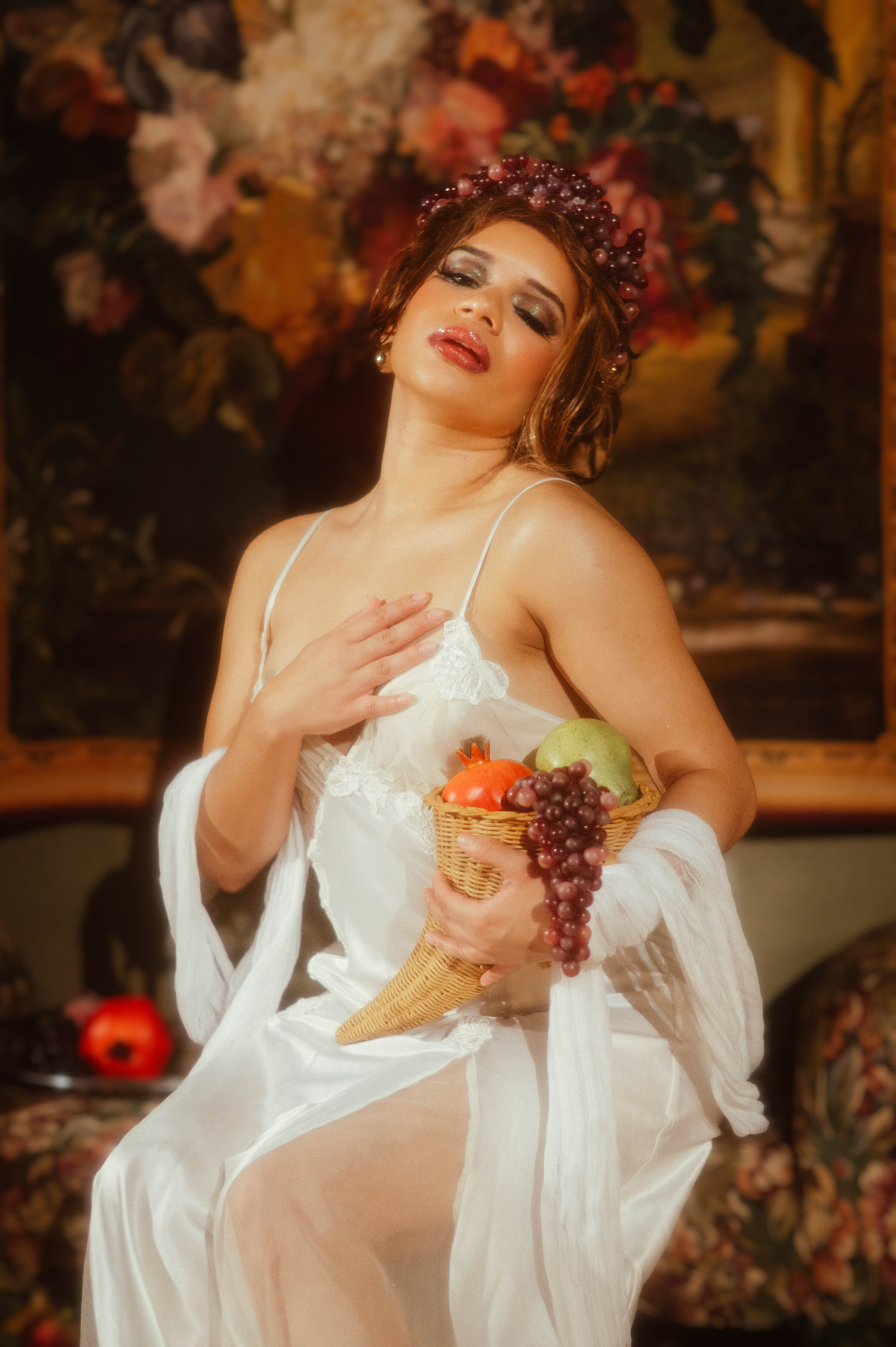 Close up of a woman in a vintage nightgown with a burgundy grape crown resting one hand at her chest, Royal Lune Photo.