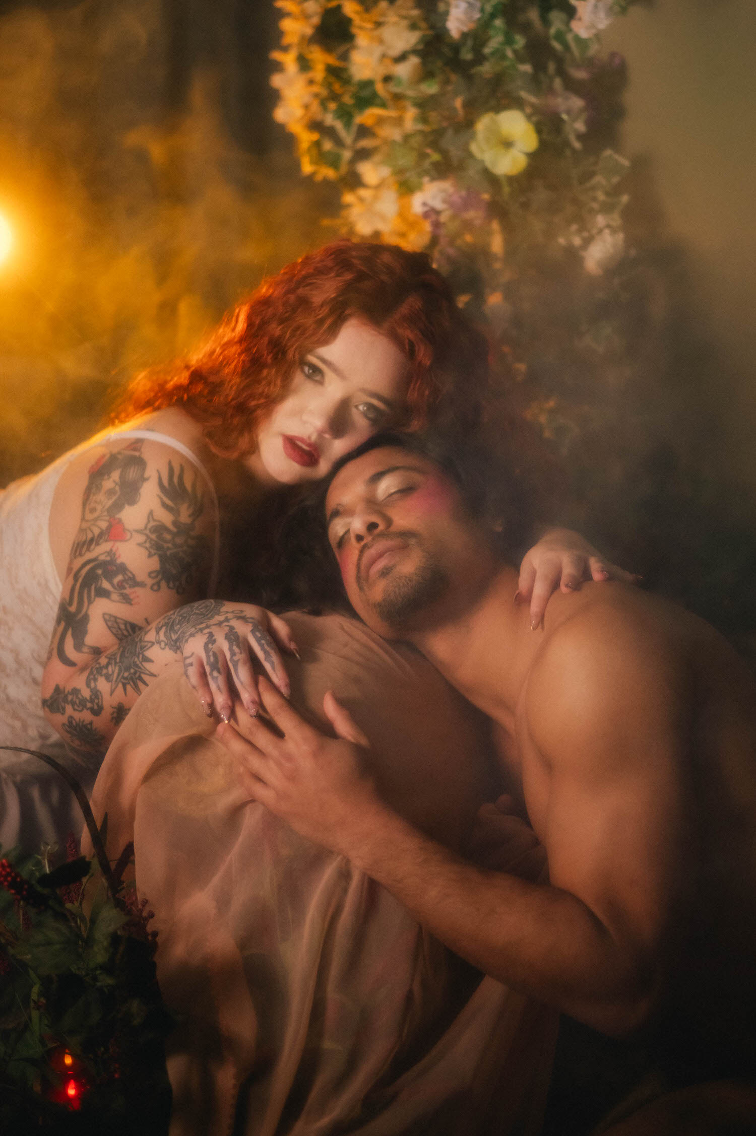 Romantic couples photography Texas portrait of a woman resting against her partner's head, golden haze and trailing florals framing the pair in soft evening light. Royal Lune Photo